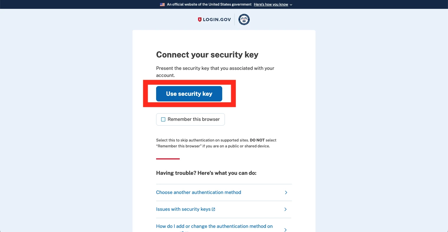 The Login.gov two-factor screen headed 'Connect your security key' with the blue 'Use security key' button highlighted, above an unticked 'Remember this browser' checkbox and a 'Choose another authentication method' link.